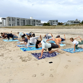 company retreat yoga on beach